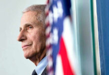 Anthony Fauci close-up with flag.