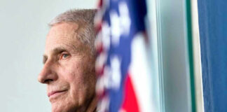 Anthony Fauci close-up with flag.