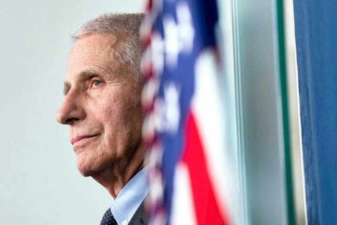 shutterstock_2465460457 Anthony Fauci close-up with flag.