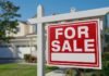 Rich Buyers Hijack Housing? A 'For Sale' sign in front of a house