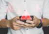 Hands holding a smartphone with warning icons overlay
