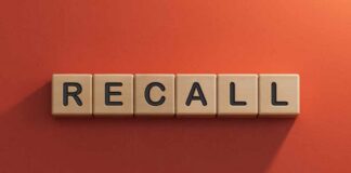 Wooden letter tiles spelling recall on an orange background
