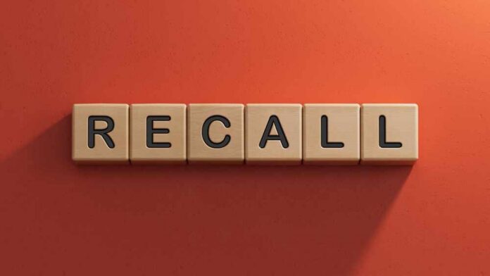 Wooden letter tiles spelling recall on an orange background