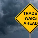 Trade War Escalates — Canada Hits Back Yellow warning sign reads Trade Wars Ahead