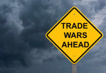 Trade War Escalates — Canada Hits Back Yellow warning sign reads Trade Wars Ahead