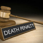 DEATH: Court Drops The Hammer Gavel beside death penalty sign on desk
