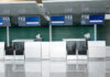 Empty airport check-in counters G11 to G14.
