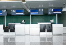 Empty airport check-in counters G11 to G14.