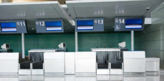 Empty airport check-in counters G11 to G14.