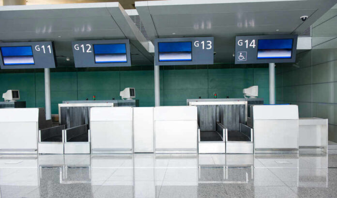 shutterstock_475149466 Empty airport check-in counters G11 to G14.