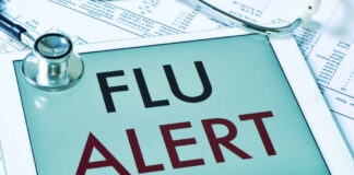 Tablet displaying a flu alert message with a stethoscope nearby