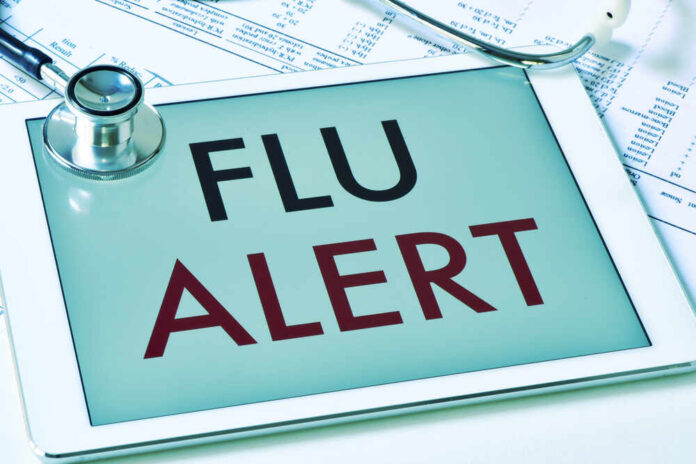 Closeup,Of,A,Tablet,Computer,With,The,Text,Flu,Alert Tablet displaying a flu alert message with a stethoscope nearby