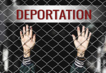 Hands reaching through a chain-link fence with the word 'DEPORTATION' above