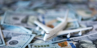 Toy airplane on scattered US dollar bills