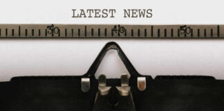 Close-up of a typewriter with a sheet of paper displaying the words 'LATEST NEWS'