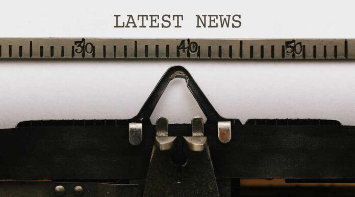 Close-up of a typewriter with a sheet of paper displaying the words 'LATEST NEWS'