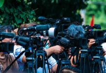 VIDEO: Against All Odds Dion Roars Back TV news cameras crowding together at an outdoor event