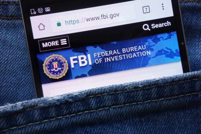 Mobile phone displaying the FBI website in a denim pocket