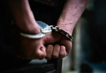 ARRESTED: Creepy Cops Caught Stalking With THIS!? Close-up of hands in handcuffs behind back.