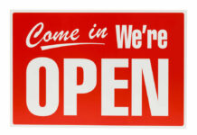 Popular Store Roars Back To Life Red Come in, Were Open sign.