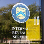 IRS office entrance door with agency seal and notice