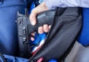 VIDEO: 11 Shot In School Ambush A hand holding a gun inside a backpack