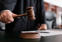 Torture Plot Exposed — Judge Drops Hammer Judge holding gavel in courtroom.