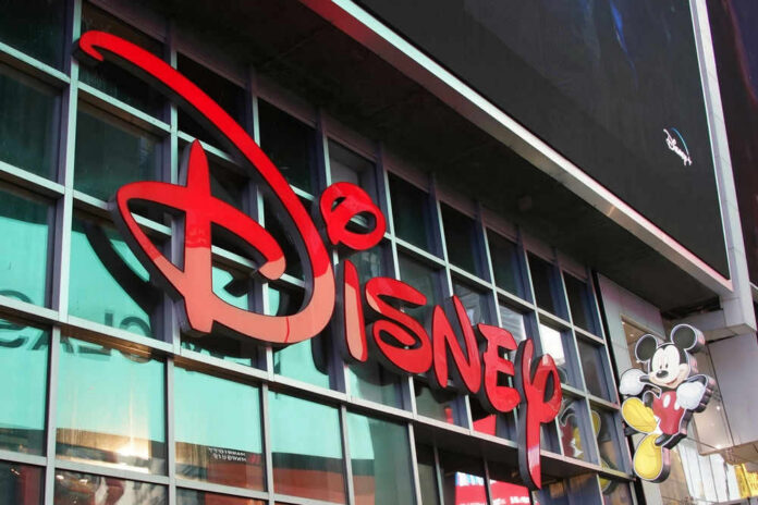 shutterstock_2212408911 Disney sign on building with Mickey Mouse figure