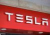 Tesla’s $50K Clock Starts Ticking Tesla logo displayed on a red background
