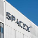 MUSK Bets $100B On Louisiana Marsh SpaceX logo on the side of a white industrial building