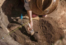 Huge Reveal Under Christianity’s Holiest Site Archaeologist uncovering pottery at a dig site.