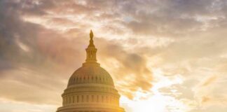The Capitol building in Washington D.C. silhouetted against a sunset