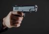 Warnings Ignored — Then A Mass Shooting Hand holding a semi-automatic pistol pointed forward