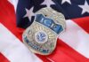 FBI Perjury Trap? ICE Officer Indicted ICE officer badge resting on an American flag