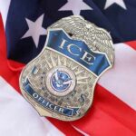 FBI Perjury Trap? ICE Officer Indicted ICE officer badge resting on an American flag
