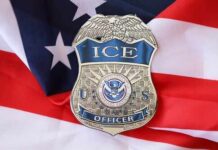 Officer Arrested In Deadly ICE Raid ICE officer badge placed on an American flag