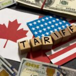 Price Shock Incoming: Border Heat Rises Wooden blocks spelling tariffs on U.S. and Canadian flags with dollar bills