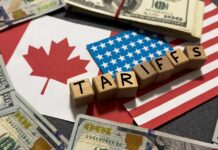 Price Shock Incoming: Border Heat Rises Wooden blocks spelling tariffs on U.S. and Canadian flags with dollar bills