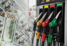 NEW HIGH: Diesel Shock Slams Prices Nationwide Fuel pump nozzles next to spread of U.S. hundred-dollar bills