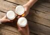 DETAILS: Gen Z Slams the Brakes on Booze Three hands holding beer glasses in a toast