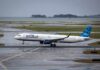 Airline Shake-Up: JetBlue Ups the Game jetBlue airplane taxiing on a wet runway near the coast