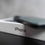 Google and Apple logos on smartphones.