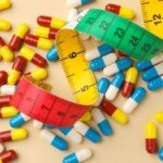 Governor’s 80-Pound Drop Sparks 2028 Buzz Colorful capsules scattered with a measuring tape