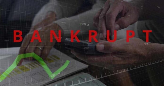 Reviewing,Senior,Partners,Wearing,Suits,Examining,Financials,At,Desk,,Holding Hands using a smartphone with a financial chart and the word 'BANKRUPT' overlayed