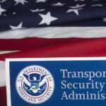 TSA Lets Non-Flyers Do WHAT? Transportation Security Administration sign in front of an American flag