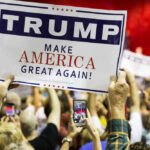 RIGHT NOW: Dallas Becomes GOP’s Launchpad People holding Trump Make America Great Again signs.