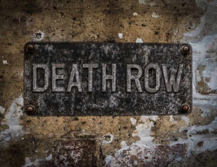 shutterstock_533872477 Weathered metal sign reading 'DEATH ROW' on a wall