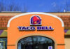 Exterior view of a Taco Bell restaurant with a colorful sign