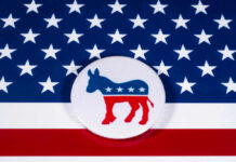 VIDEO: Armed Man Lunges at Democrat Gubernatorial Candidate Democratic Party donkey logo on American flag background.