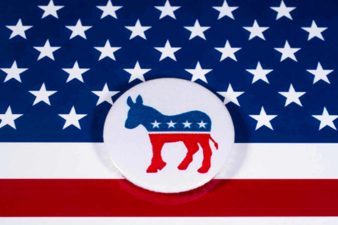 shutterstock_7864500311 Democratic Party donkey logo on American flag background.